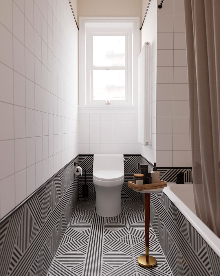 small bathroom with geometric black-and-white tiles